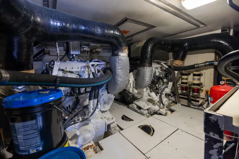 Freedom Yacht Photos Pics Engine room of a 2005 Azimut 68 yacht, featuring complex machinery and piping.