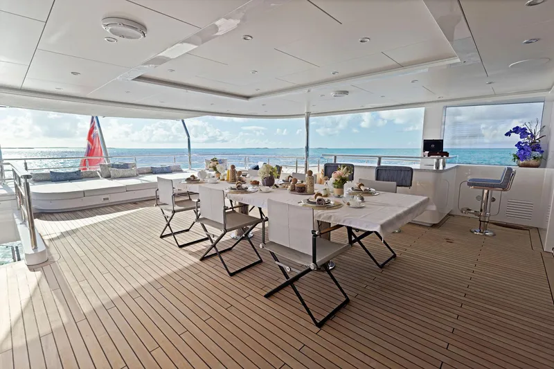 Moonraker Yacht Photos Pics Luxurious Bilgin 156 yacht deck with elegant dining setup, ocean view, and modern design.