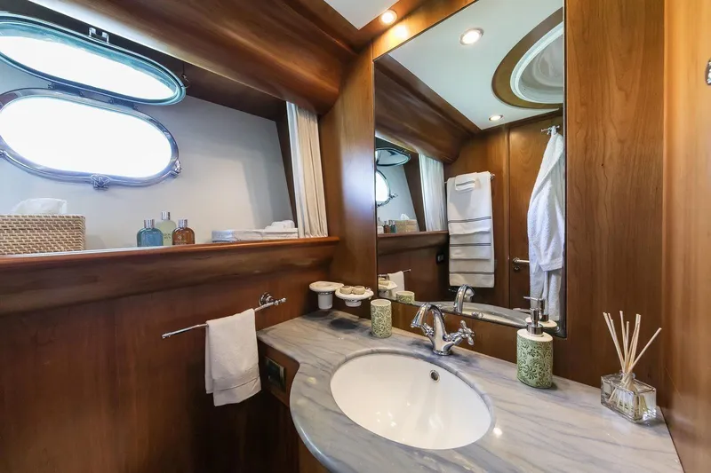  Yacht Photos Pics Luxurious bathroom in 2004 Canados 72s yacht with elegant wood finish and modern fixtures.
