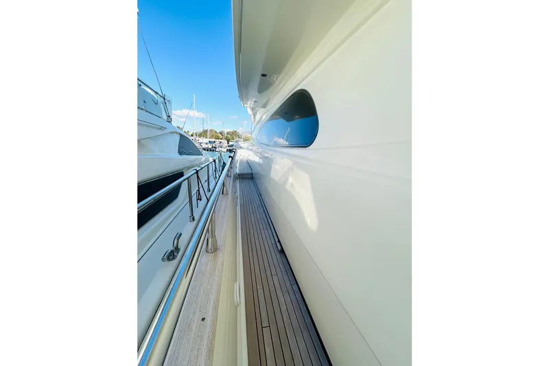  Yacht Photos Pics Side view of 2004 Canados 72s yacht with sleek design and wooden deck.