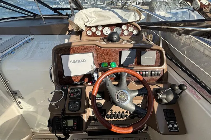  Yacht Photos Pics Helm of 2005 Regal Commodore 4260 with navigation equipment and controls.