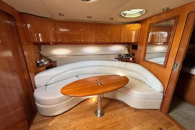  Yacht Photos Pics Luxurious 2005 Regal Commodore 4260 yacht interior with curved seating and elegant wood finishes.