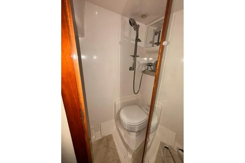  Yacht Photos Pics Compact bathroom in 2005 Regal Commodore 4260 yacht with shower and toilet.