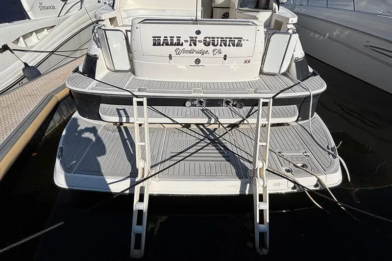  Yacht Photos Pics 2005 Regal Commodore 4260 yacht docked, featuring a swim platform and ladder.