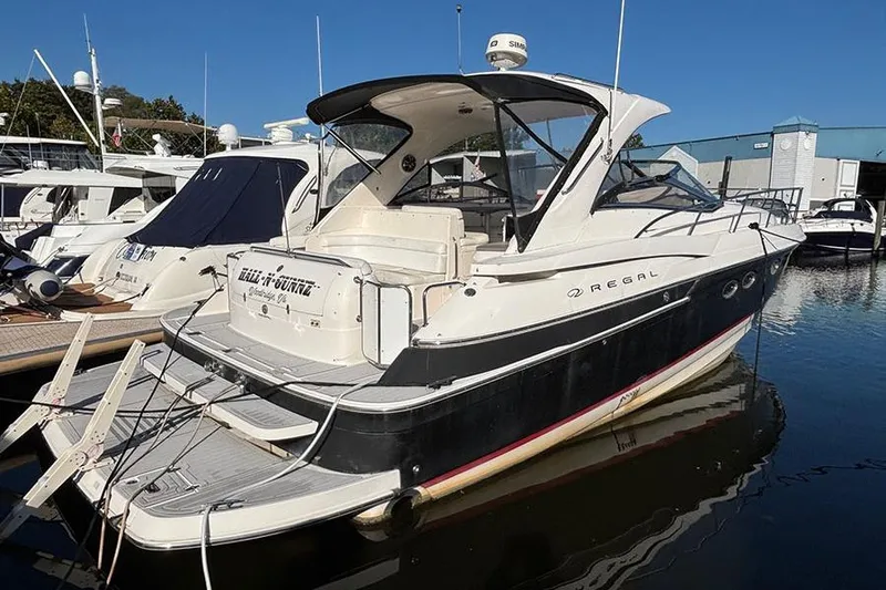  Yacht Photos Pics 2005 Regal Commodore 4260 yacht docked at marina under clear blue sky.