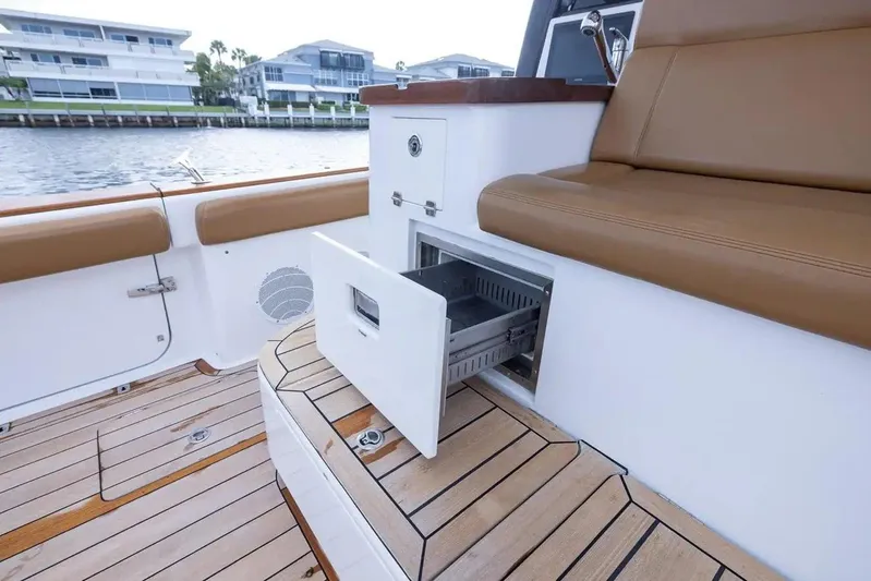 Next To Sell Yacht Photos Pics 2020 HCB Estrella boat interior with open storage compartment and tan seating.