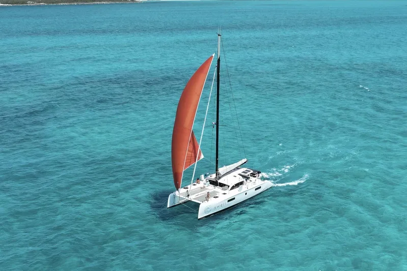 Swell Yacht Photos Pics Outremer 51 catamaran sailing in clear turquoise waters, 2021 model.