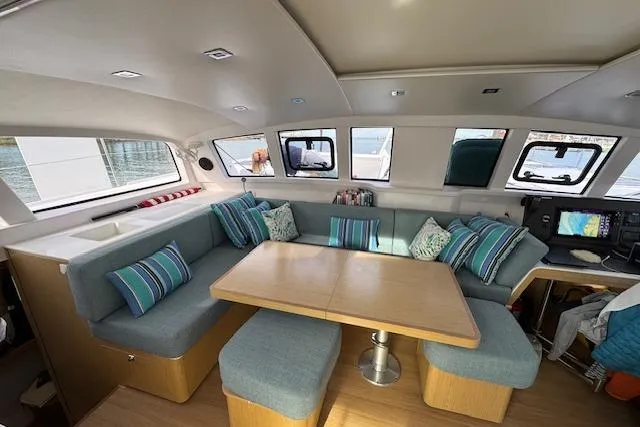Swell Yacht Photos Pics Interior of 2021 Outremer 51 catamaran with cozy seating and navigation area.