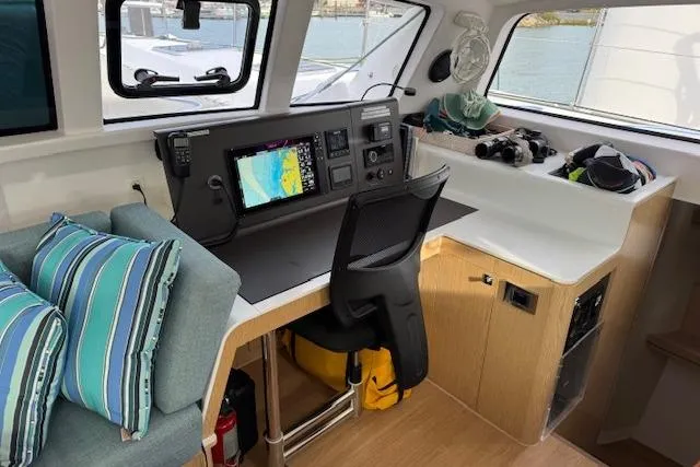 Swell Yacht Photos Pics Interior of 2021 Outremer 51 yacht with navigation station and seating area.