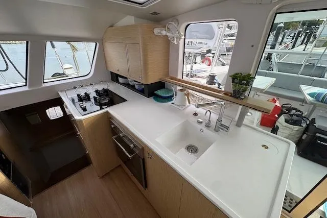 Swell Yacht Photos Pics Modern kitchen interior of 2021 Outremer 51 yacht with sleek design and appliances.