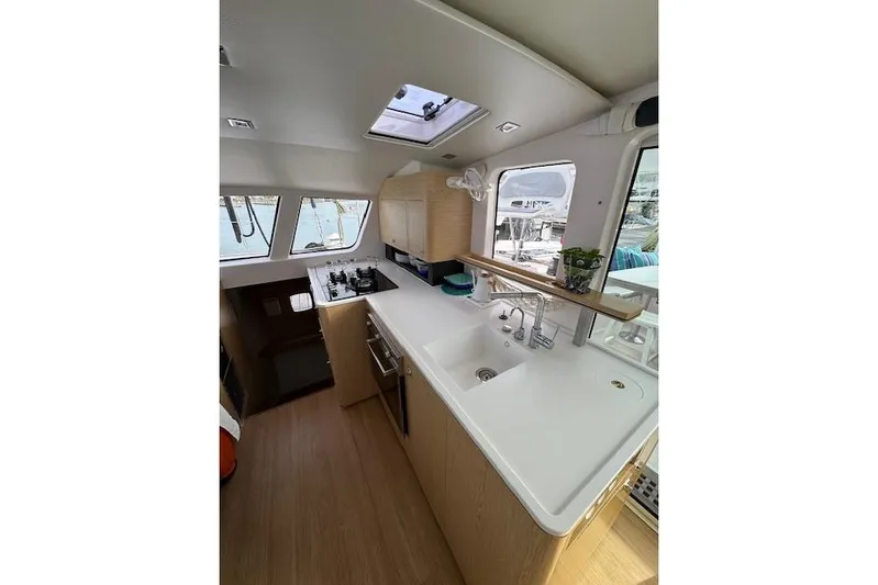 Swell Yacht Photos Pics Modern kitchen interior of 2021 Outremer 51 yacht with sleek design and ample natural light.
