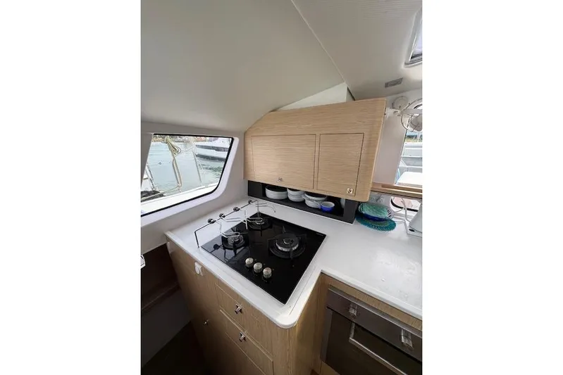 Swell Yacht Photos Pics Modern kitchen in 2021 Outremer 51 yacht with stove and cabinetry.