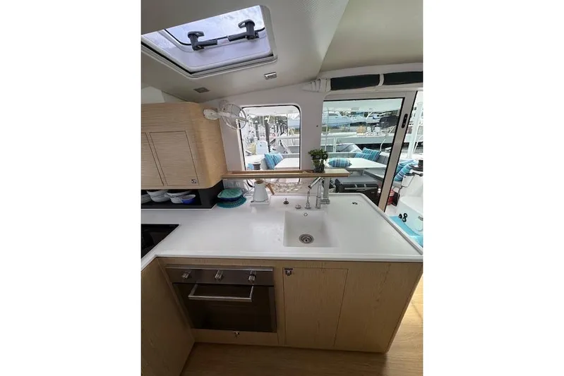 Swell Yacht Photos Pics Modern kitchen interior of 2021 Outremer 51 yacht with sleek design and ample natural light.