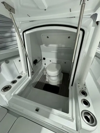 36 Yellowfin Yacht Photos Pics 2024 Yellowfin 36 boat interior with a compact marine toilet and storage space.