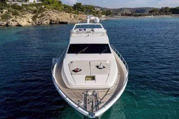 Golden Ex Yacht Photos Pics 2001 Ferretti Yachts 680 cruising in clear blue waters near rocky coastline.