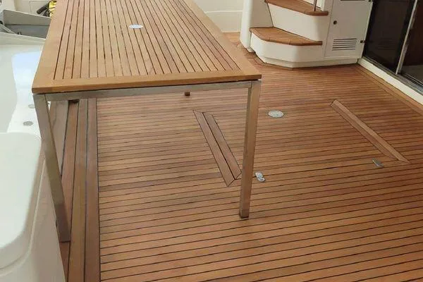 Golden Ex Yacht Photos Pics Teak deck of 2001 Ferretti Yachts 680 with wooden table and stairs.