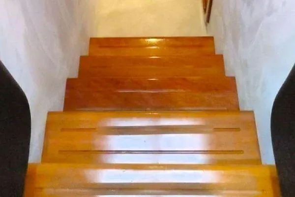 Golden Ex Yacht Photos Pics Wooden stairs inside a 2001 Ferretti Yachts 680, showcasing polished finish.