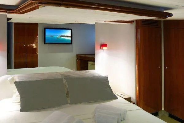Golden Ex Yacht Photos Pics Luxurious bedroom interior of 2001 Ferretti Yachts 680 with modern amenities.