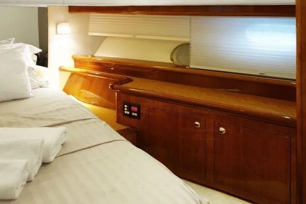 Golden Ex Yacht Photos Pics Luxurious cabin interior of 2001 Ferretti Yachts 680 with elegant wood finish.