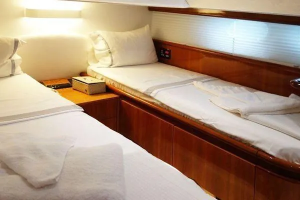 Golden Ex Yacht Photos Pics Luxurious twin cabin in 2001 Ferretti Yachts 680, featuring elegant wood finishes.