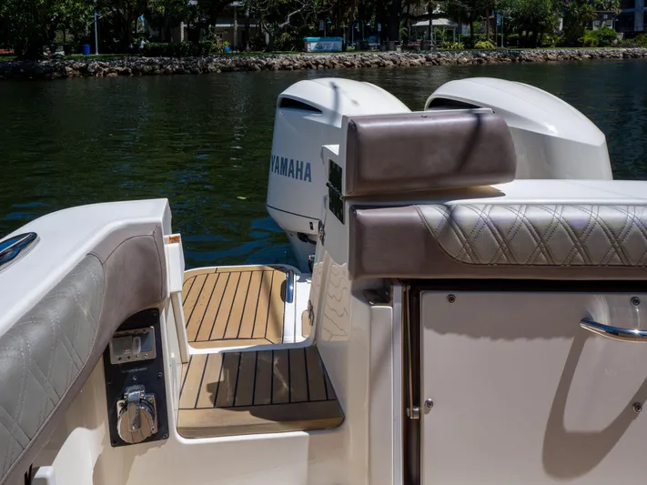  Yacht Photos Pics 2015 Scout 320 LFX boat with Yamaha engines, featuring teak deck and cushioned seating.