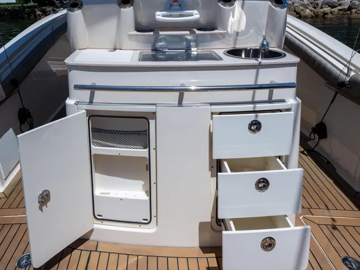  Yacht Photos Pics 2015 Scout 320 LFX boat kitchen with open storage and sink on teak deck.