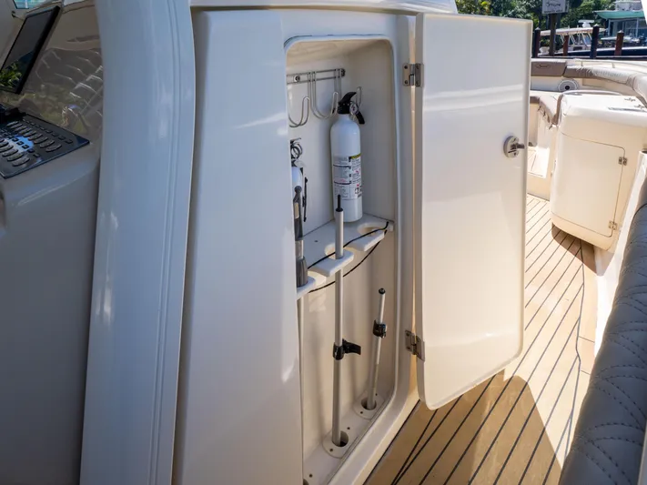  Yacht Photos Pics Open storage compartment on 2015 Scout 320 LFX boat deck with fire extinguisher.