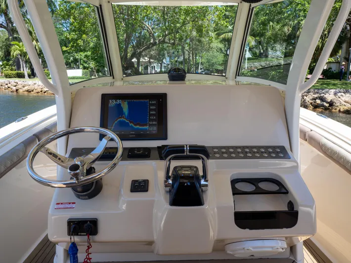  Yacht Photos Pics 2015 Scout 320 LFX boat dashboard with steering wheel and navigation display.