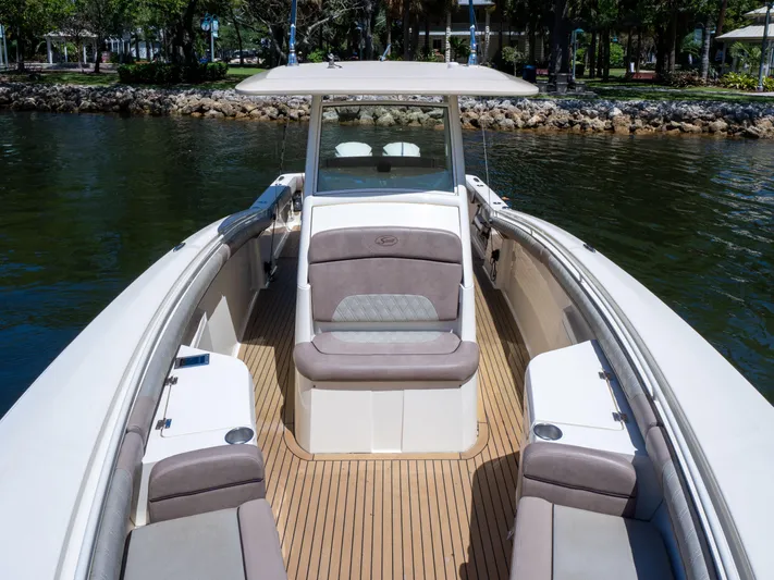  Yacht Photos Pics 2015 Scout 320 LFX boat with spacious seating and sleek design on calm water.