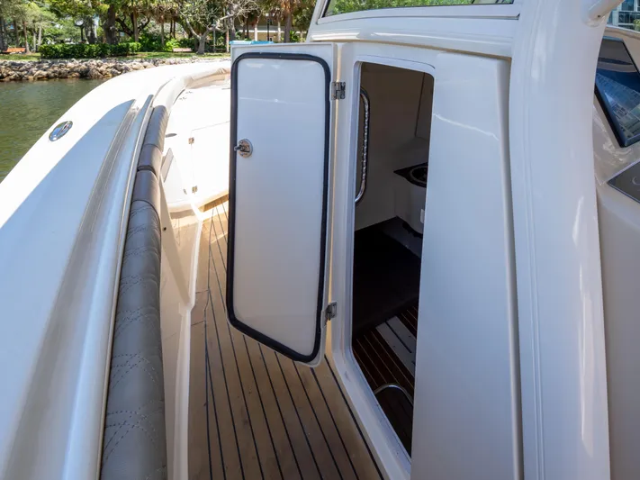  Yacht Photos Pics 2015 Scout 320 LFX boat with open cabin door and teak flooring.