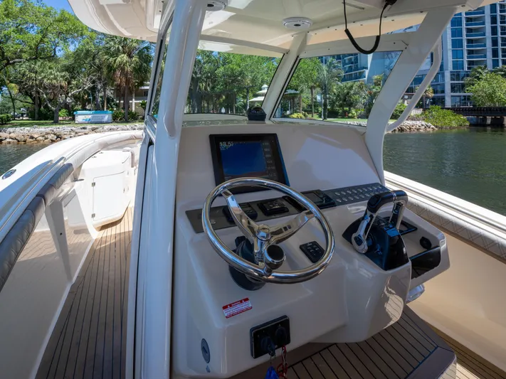 Yacht Photos Pics 2015 Scout 320 LFX boat cockpit with steering wheel and control panel.