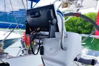 Cockpit of 2019 Custom Patago 40 sailboat with navigation equipment and lush greenery in background.