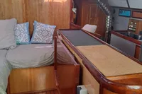 Luxurious interior of 2019 Custom Patago 40 yacht with wood finish and cozy bedding.