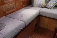 Cozy cabin interior of 2019 Custom Patago 40 yacht with wooden finish and cushioned seating.