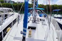 Sailboat deck view, Custom Patago 40, 2019 model, docked under a partly cloudy sky.