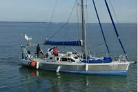 Sailing yacht "Lucky II," Custom Patago 40, 2019, on calm waters with crew onboard.