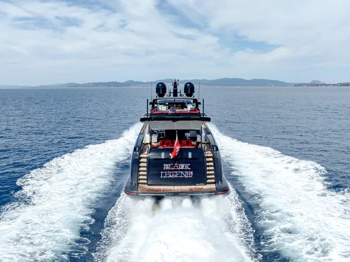 Black Legend Yacht Photos Pics Luxurious 2017 Mangusta 165E yacht cruising on open sea, leaving a wake behind.