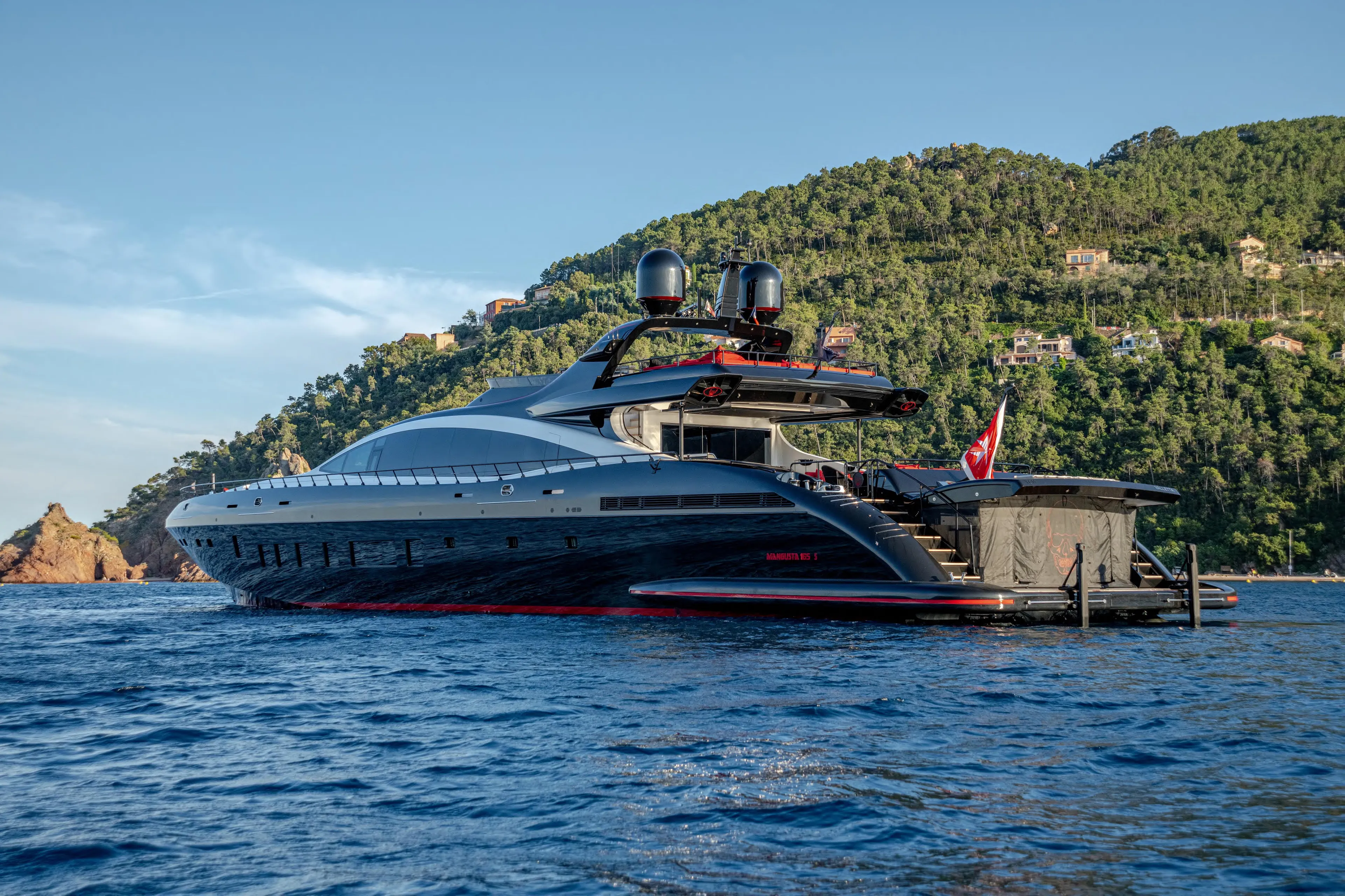 Black Legend Yacht Photos Pics Luxurious 2017 Mangusta 165E yacht cruising near scenic coastline.