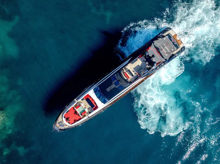 Black Legend Yacht Photos Pics Aerial view of 2017 Mangusta MANGUSTA 165E yacht cruising in clear blue waters.