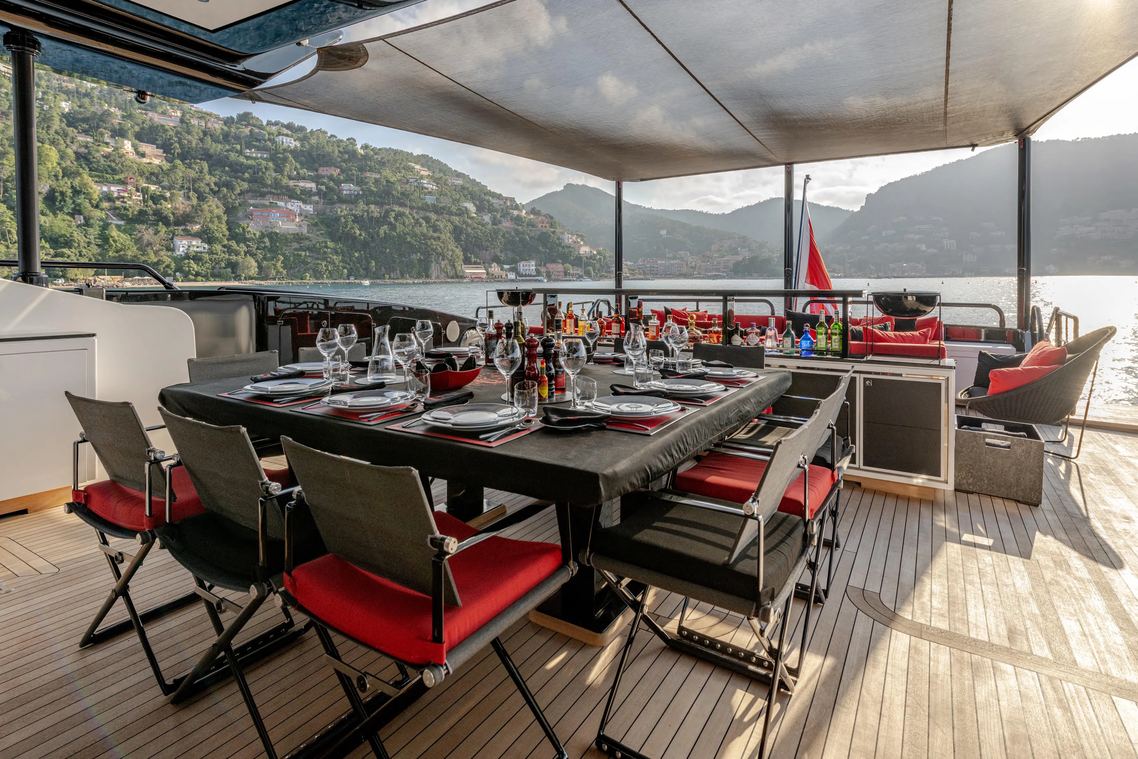 Black Legend Yacht Photos Pics Luxurious dining area on 2017 Mangusta 165E yacht with scenic waterfront view.