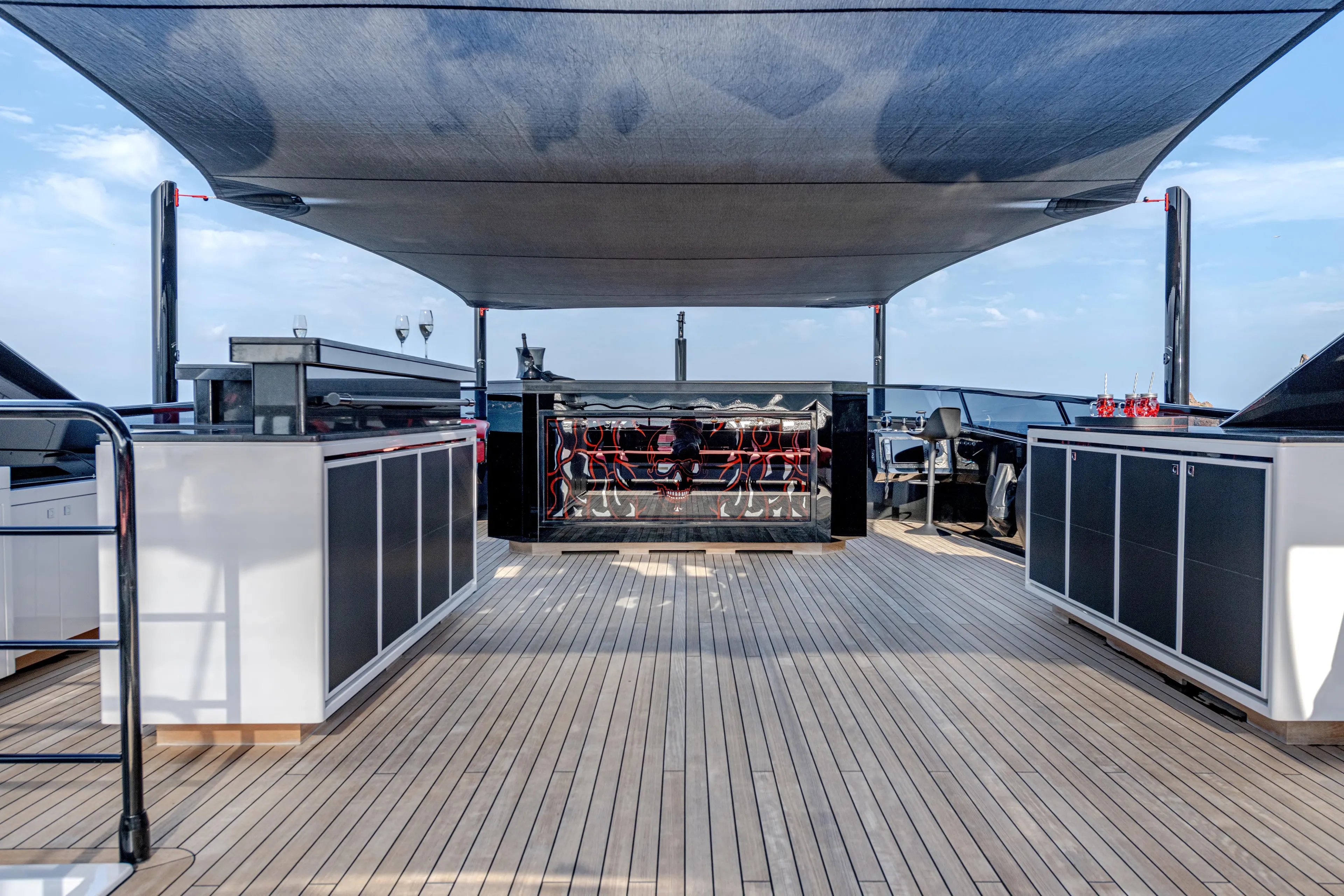 Black Legend Yacht Photos Pics Luxurious deck of 2017 Mangusta 165E yacht with modern amenities and shaded seating area.