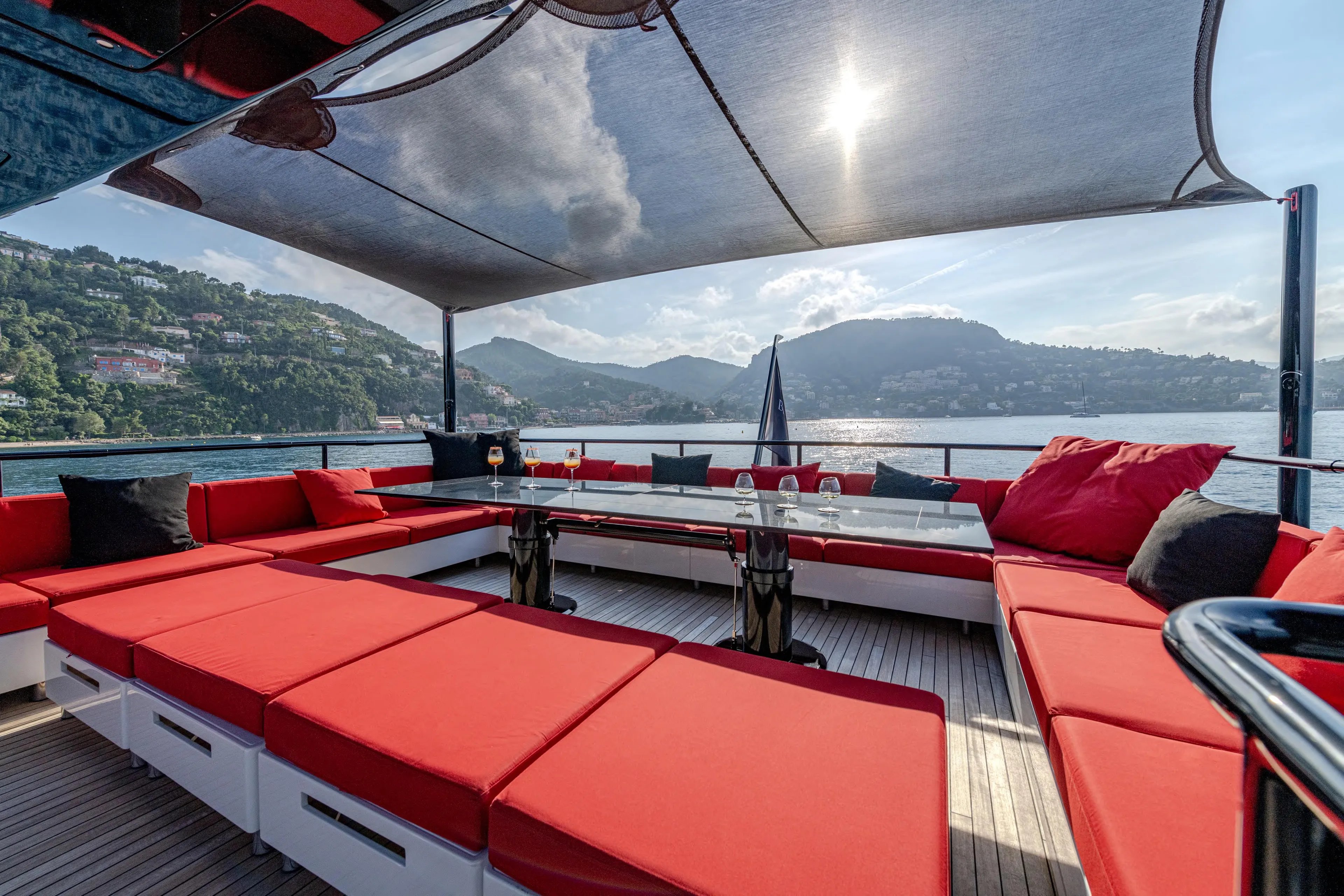 Black Legend Yacht Photos Pics Luxurious 2017 Mangusta 165E yacht with spacious red seating and scenic ocean view.