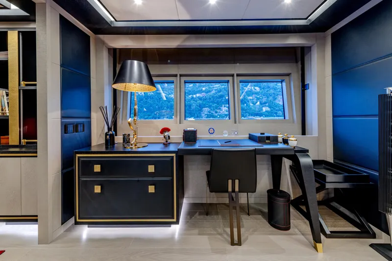 Black Legend Yacht Photos Pics Luxurious office interior on 2017 Mangusta MANGUSTA 165E yacht, featuring elegant desk and window view.