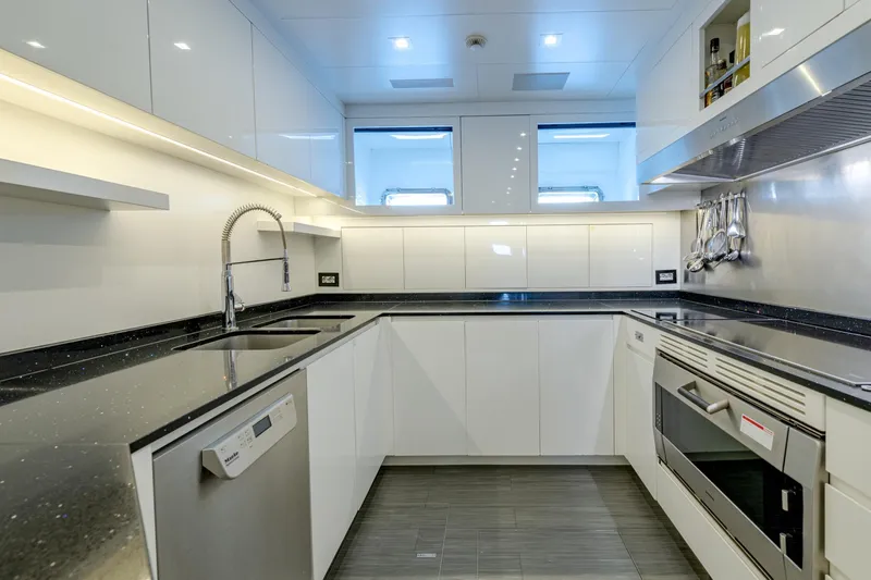 Black Legend Yacht Photos Pics Modern kitchen in 2017 Mangusta 165E yacht with sleek cabinetry and stainless steel appliances.