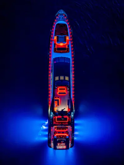 Black Legend Yacht Photos Pics Aerial view of illuminated 2017 Mangusta MANGUSTA 165E yacht on water at night.