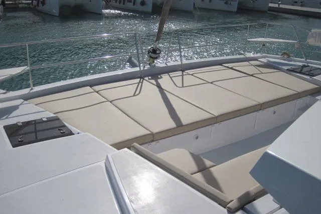  Yacht Photos Pics 2020 Bali 4.3 catamaran deck with beige sunbathing cushions, docked in a marina.