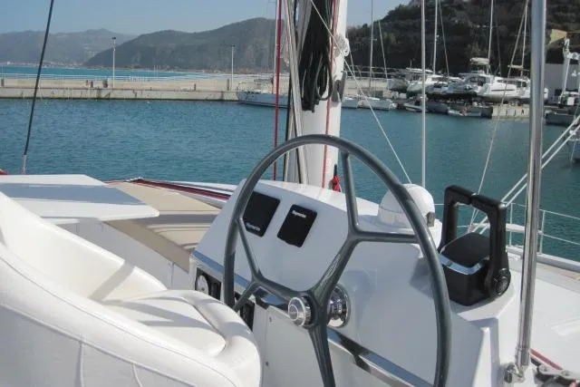  Yacht Photos Pics Steering wheel of a 2020 Bali 4.3 catamaran docked in a marina.