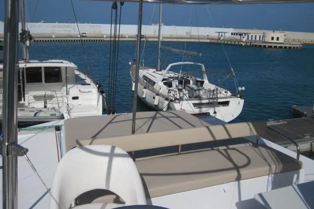  Yacht Photos Pics 2020 Bali 4.3 catamaran docked in a marina, with clear blue water.