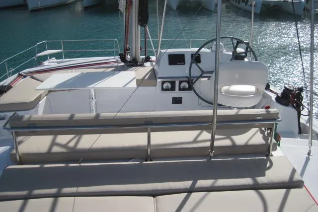  Yacht Photos Pics 2020 Bali 4.3 yacht cockpit with steering wheel and seating, docked in marina.