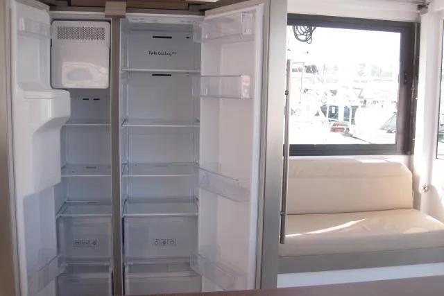 Yacht Photos Pics Spacious fridge interior on Bali 4.3 catamaran, 2020 model, with adjacent seating area.